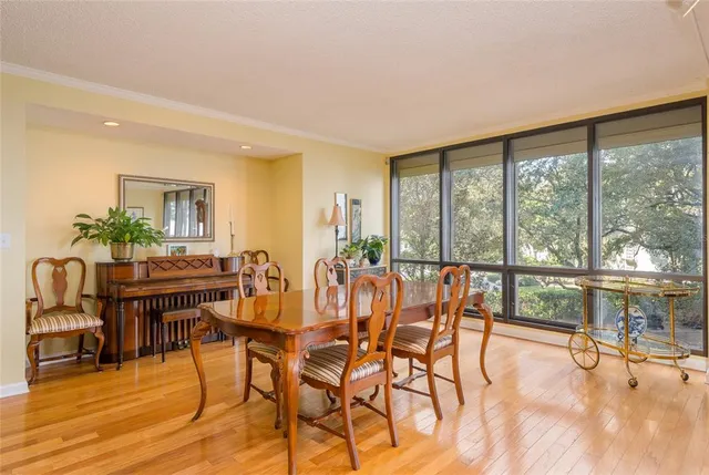 a dining room with furniture window and wooden floor