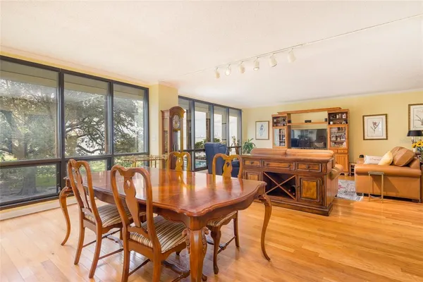 a dining room with furniture and wooden floor