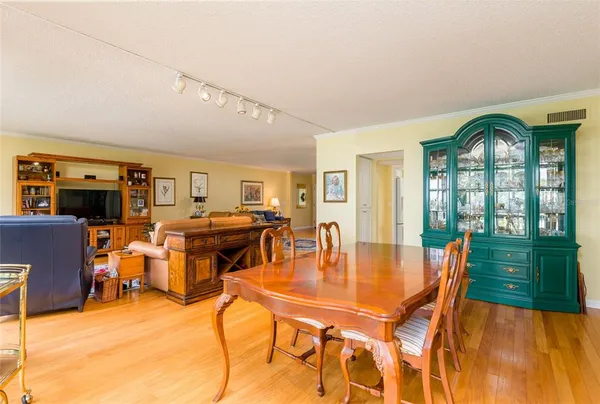 a dining room with furniture window and wooden floor