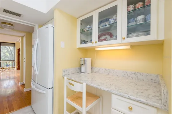 hallway with wooden floor and cabinets