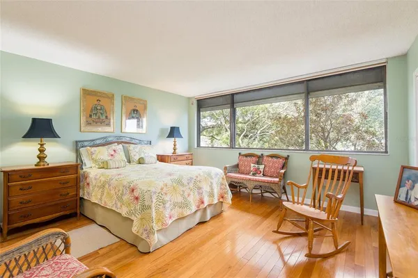 a bedroom with a bed and window