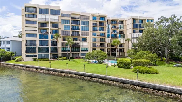 a view of a hallway with wooden floor and windows
