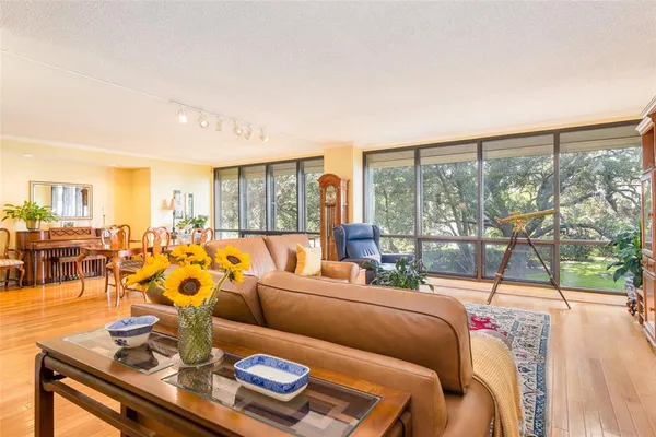 a living room with furniture and a floor to ceiling window