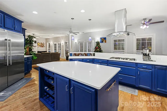 a kitchen with stainless steel appliances granite countertop a sink and a refrigerator