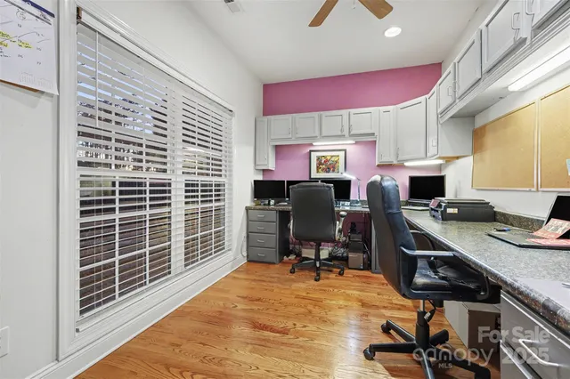 a view of a workspace with furniture and a window