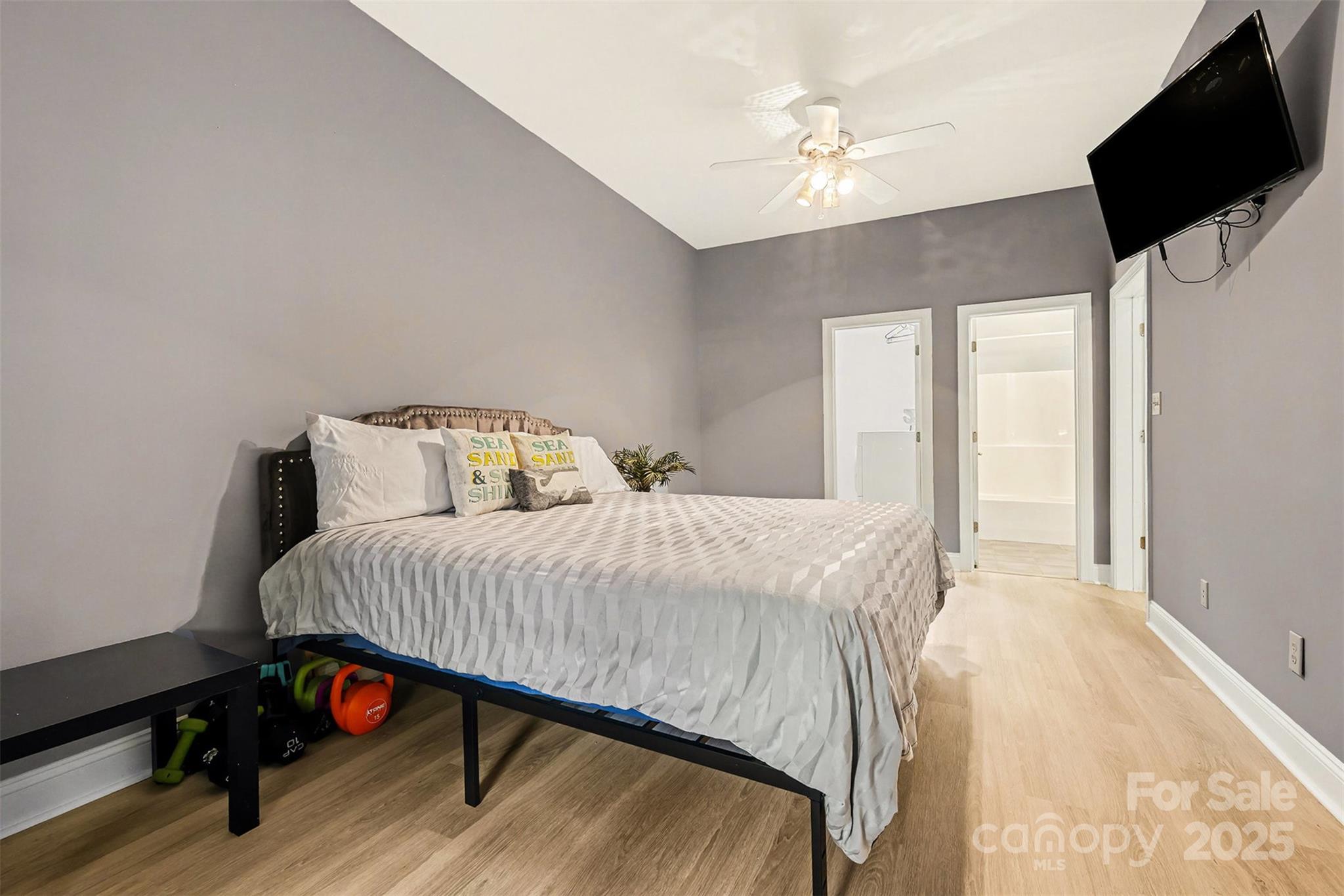 5418 Commodore Place Clover, SC 29710 - Photo 18 of 48 a bedroom with a bed a flat screen tv and a chandelier