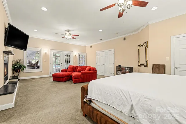 a spacious bedroom with a bed and a flat screen tv