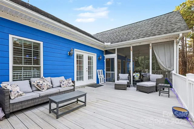 a balcony with furniture and wooden floor