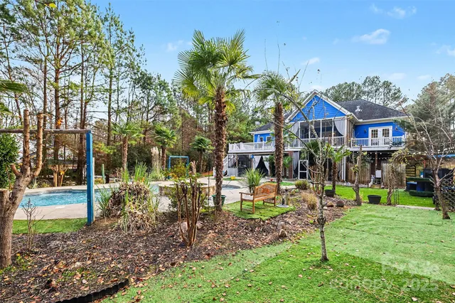 a view of a house with a yard and sitting area