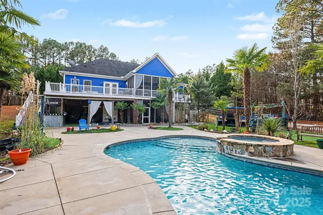 a view of a house with backyard and sitting area
