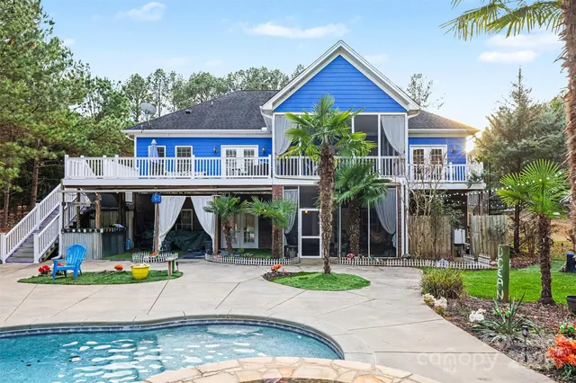 front view of house with a yard and potted plants