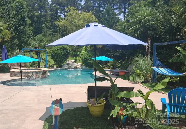 a view of a chairs and table under an umbrella