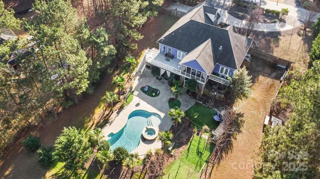 an aerial view of a house with a yard and garden