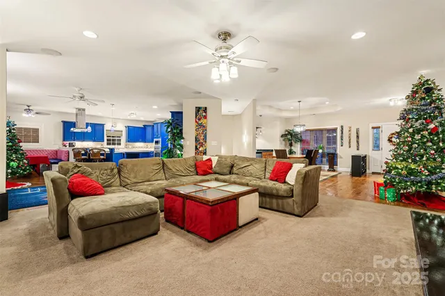 a living room with furniture kitchen and a chandelier
