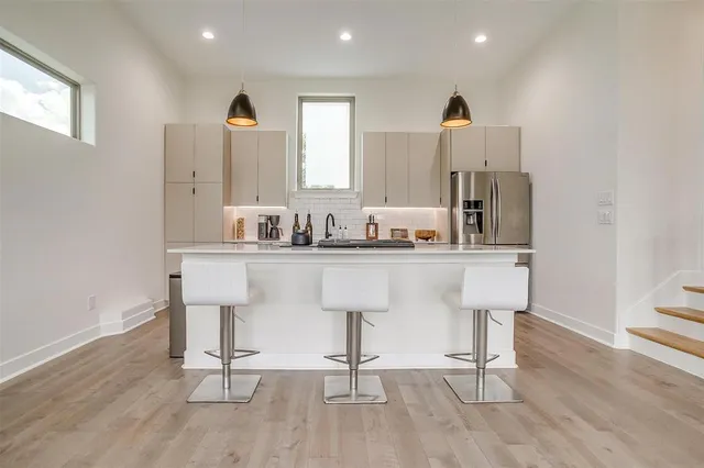 a kitchen with stainless steel appliances kitchen island granite countertop a sink and cabinets