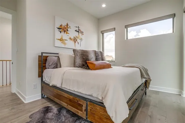 a bedroom with a bed and a painting on the wall