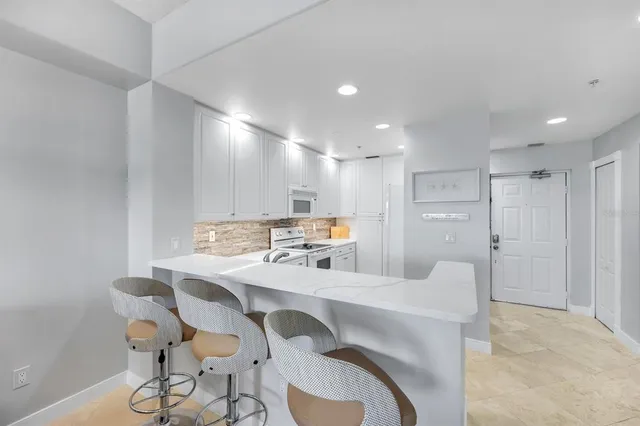 a kitchen with kitchen island a sink a counter space and cabinets