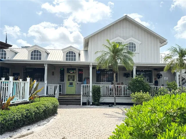 a front view of a house with a garden and plants