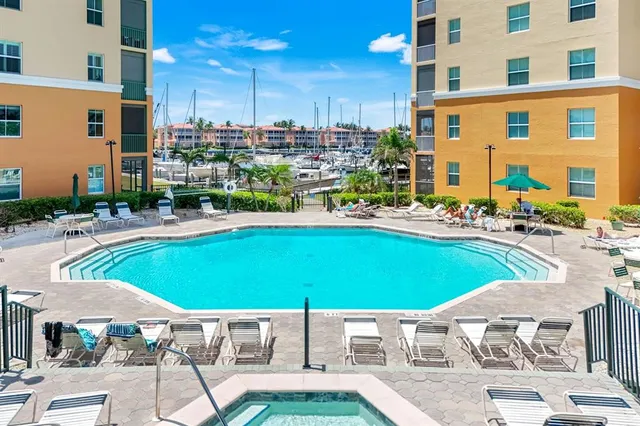 a view of a swimming pool with lawn chairs