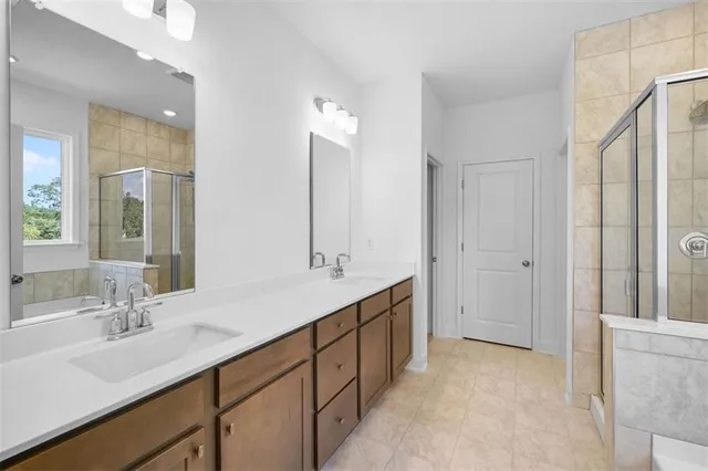 a bathroom with a double vanity sink mirror and