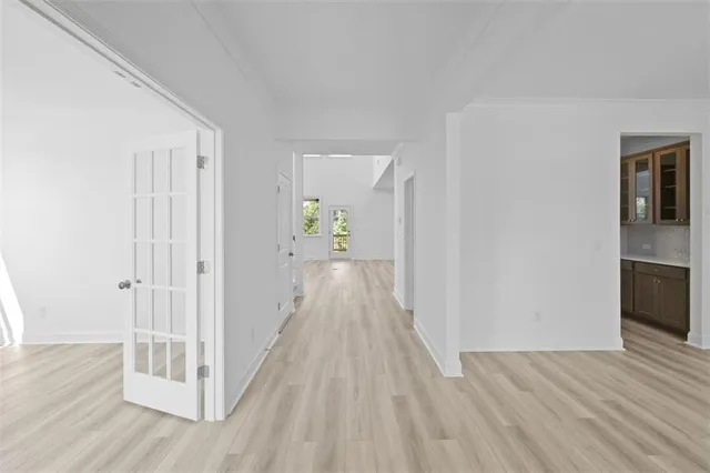 a view of a hallway with wooden floor