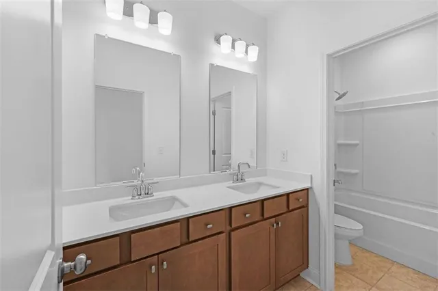 a bathroom with a sink shower and a mirror