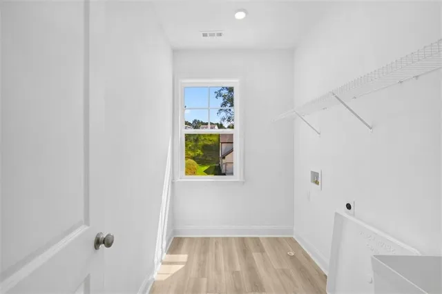 a view of an entryway with wooden floor