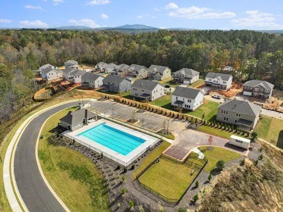an aerial view of a house with swimming pool and seating space