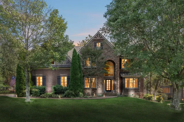 front view of a brick house with a yard