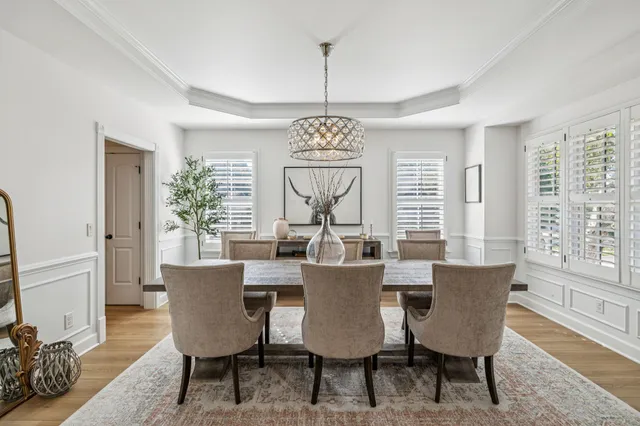 a kitchen with stainless steel appliances a sink a stove and a wooden floor
