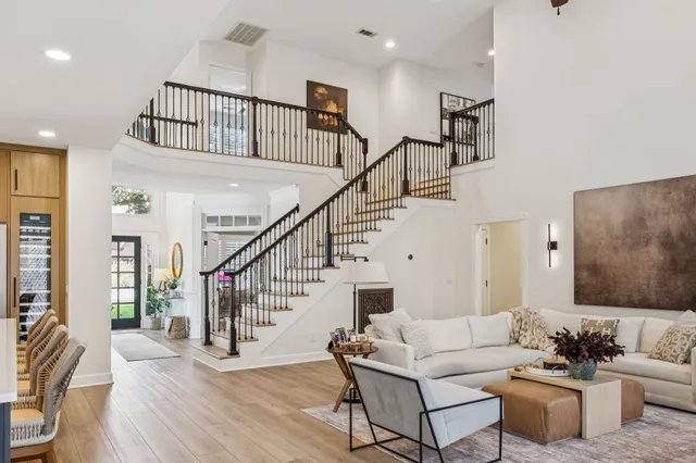 a kitchen with granite countertop kitchen island stainless steel appliances a dining table and chairs