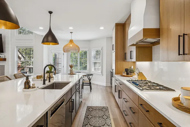 a en suite bathroom with a granite countertop sink a toilet a mirror and shower