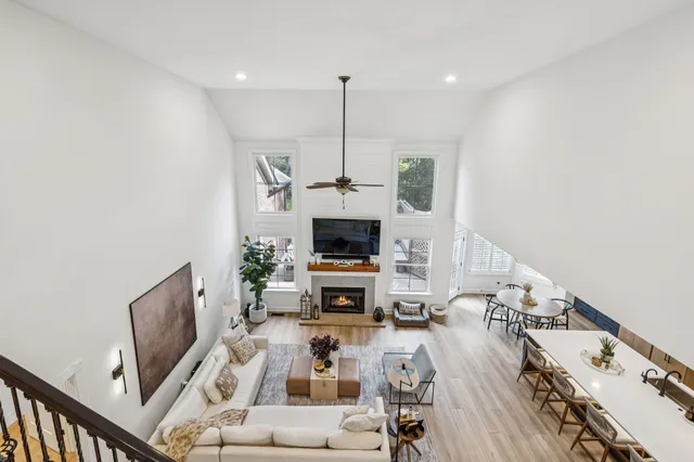 a bedroom with a large bed chandelier and a window