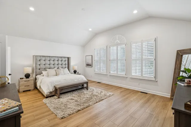 a balcony with wooden floor and outdoor seating
