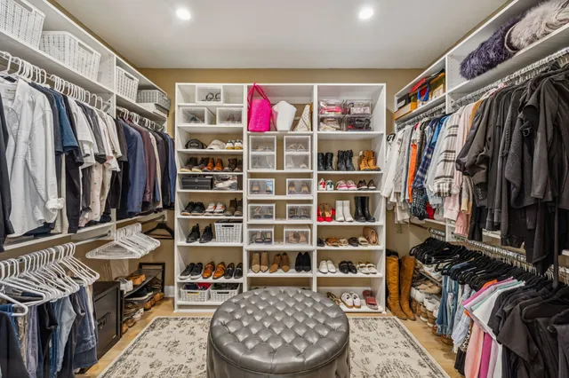 a garden with a bench and some trees in the back yard