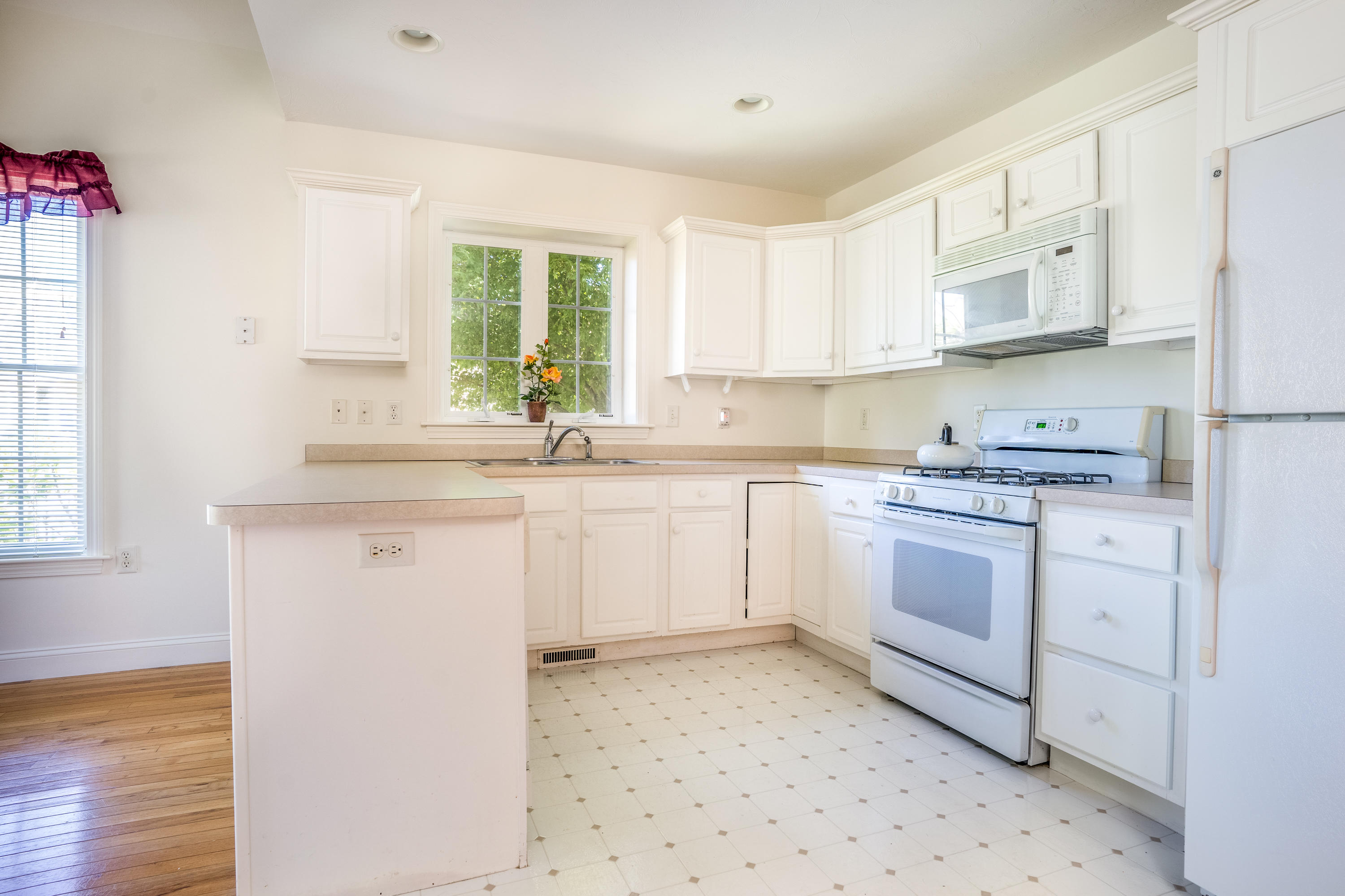 8 Stratford Ridge Mashpee, MA 02649 - Photo 5 of 23 a kitchen with granite countertop white cabinets and white appliances