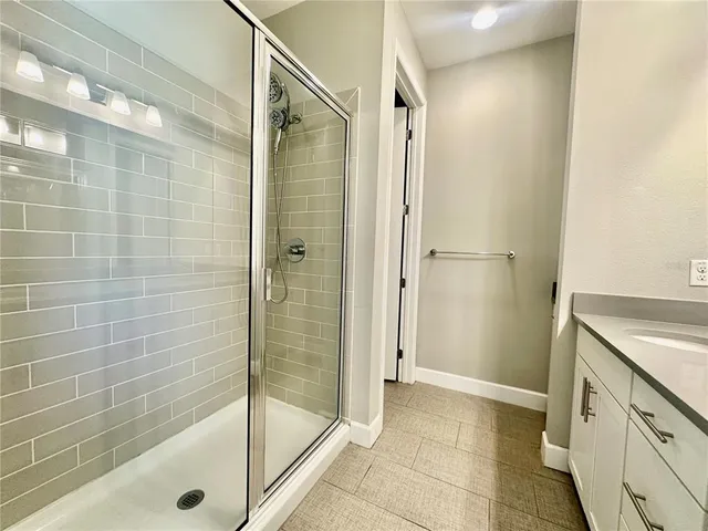 a bathroom with a shower and a sink