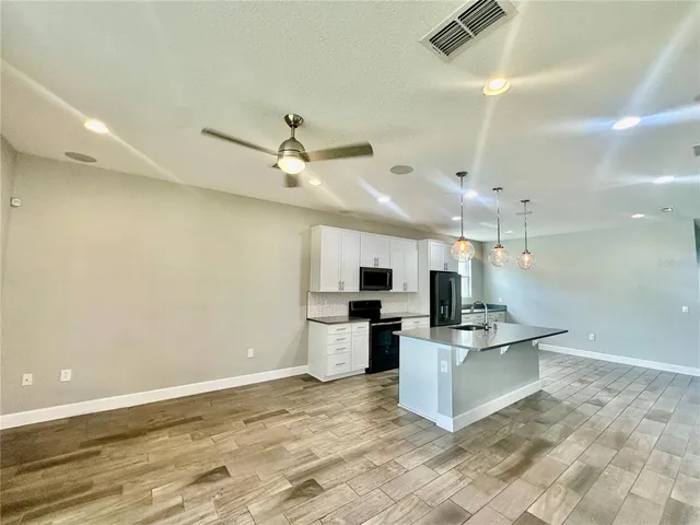 a large kitchen with cabinets and stainless steel appliances