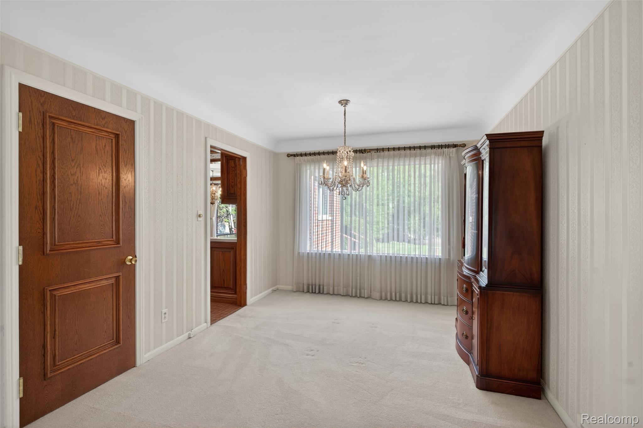 15623 Millar Road Clinton Township, MI 48036 - Photo 27 of 56 Unfurnished dining area with a chandelier and light colored carpet