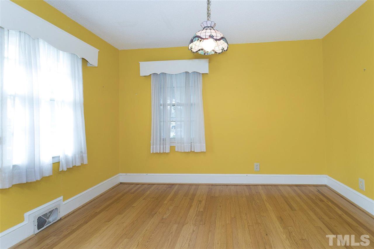6015 Inona Place Raleigh, NC 27606 - Photo 14 of 25 a view of a room with wooden floor and windows