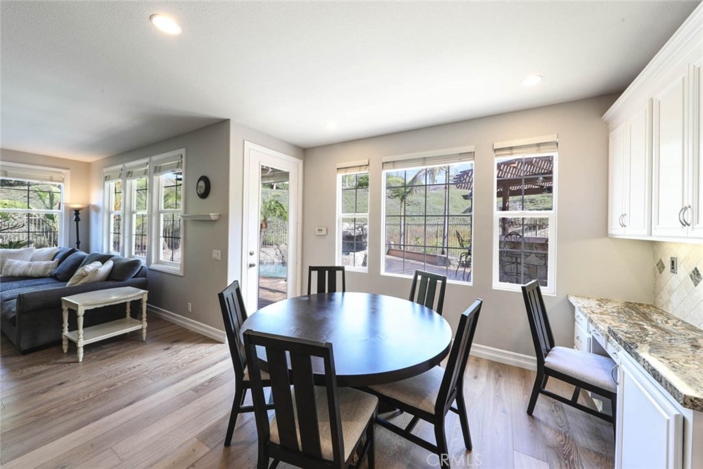 6402 Camino Ventosa San Clemente, CA 92673 - Photo 13 of 67 a view of a dining room with furniture and wooden floor