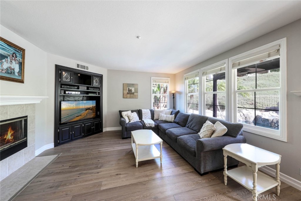 6402 Camino Ventosa San Clemente, CA 92673 - Photo 16 of 67 a living room with furniture flat screen tv and a fireplace