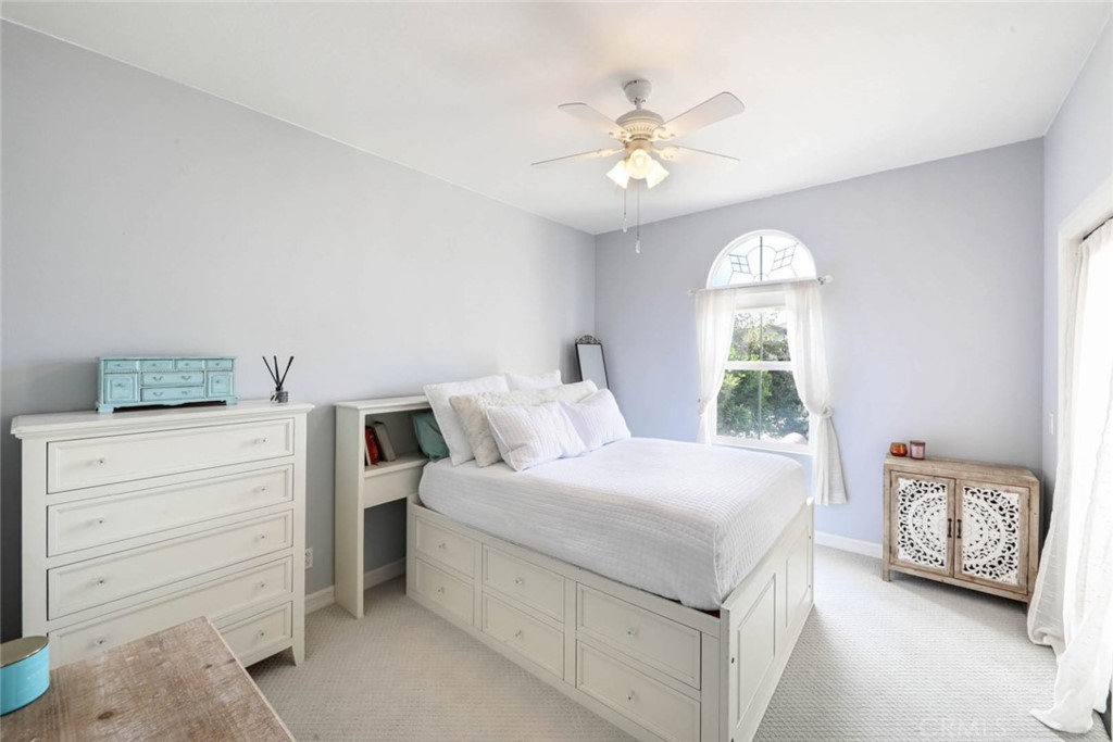 6402 Camino Ventosa San Clemente, CA 92673 - Photo 30 of 67 a bedroom with a large bed and a chandelier