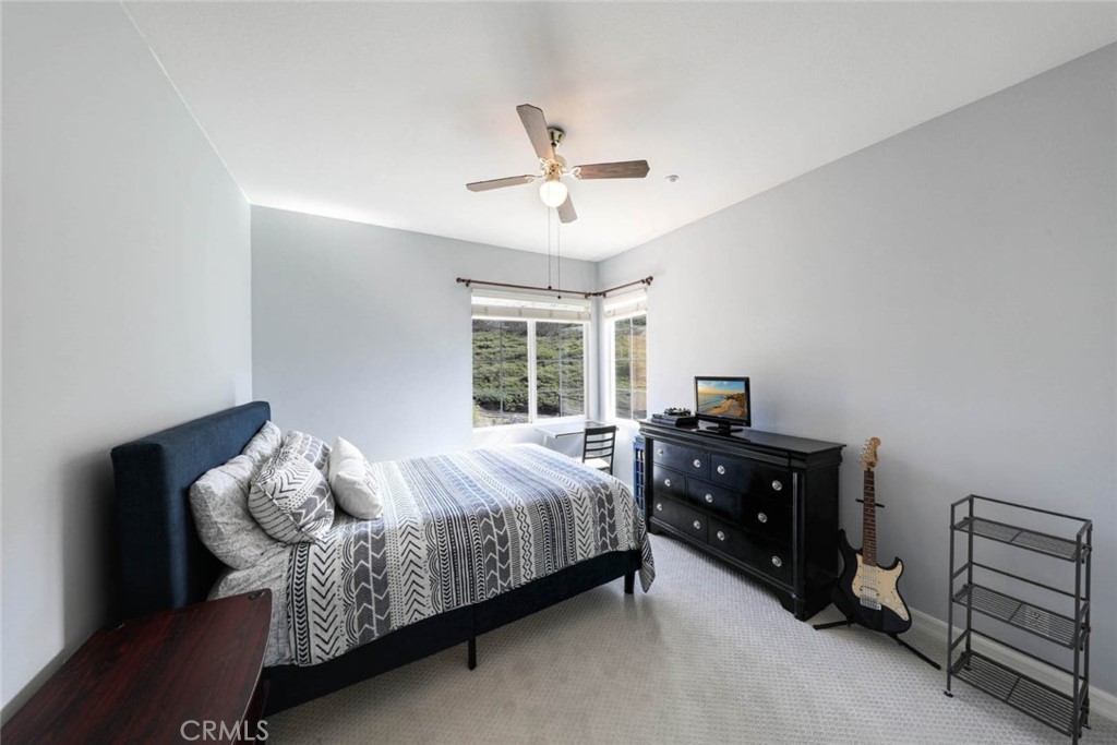 6402 Camino Ventosa San Clemente, CA 92673 - Photo 32 of 67 a bedroom with a bed and a chandelier