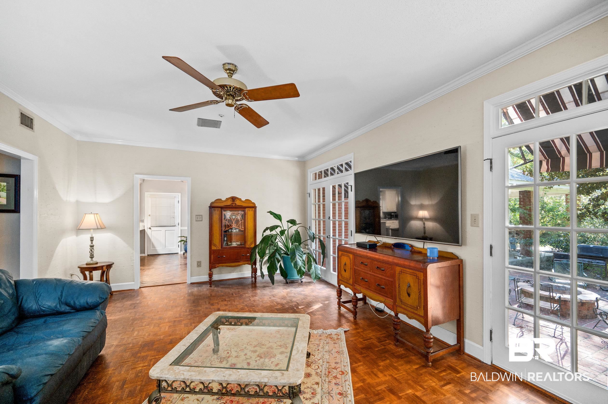 6705 Ridgeland Road South Mobile, AL 36695 - Photo 20 of 44 Living room with ornamental molding, dark parquet flooring, and ceiling fan
