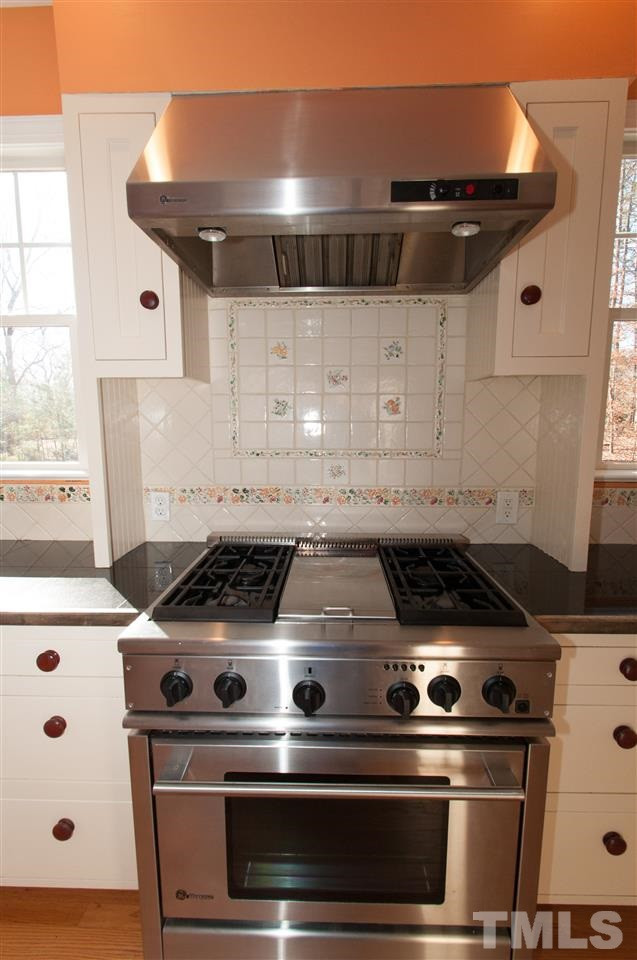 13423 Melvin Arnold Road Raleigh, NC 27613 - Photo 10 of 25 Large island/bar, granite counter top, fabulous stainless steel gas stove with grill, plenty of cabinets and a walk in pantry Kitchen