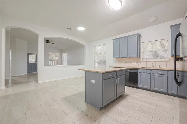 a kitchen with a sink and cabinets