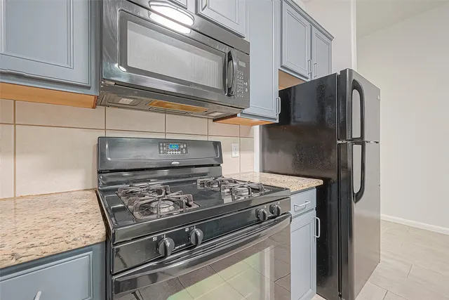 a kitchen with granite countertop cabinets and steel stainless steel appliances