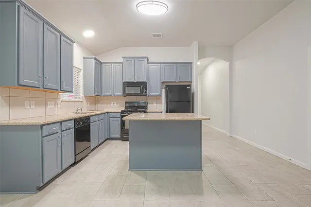 a large kitchen with cabinets and stainless steel appliances