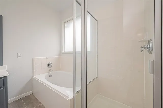 a bathroom with a bathtub and shower